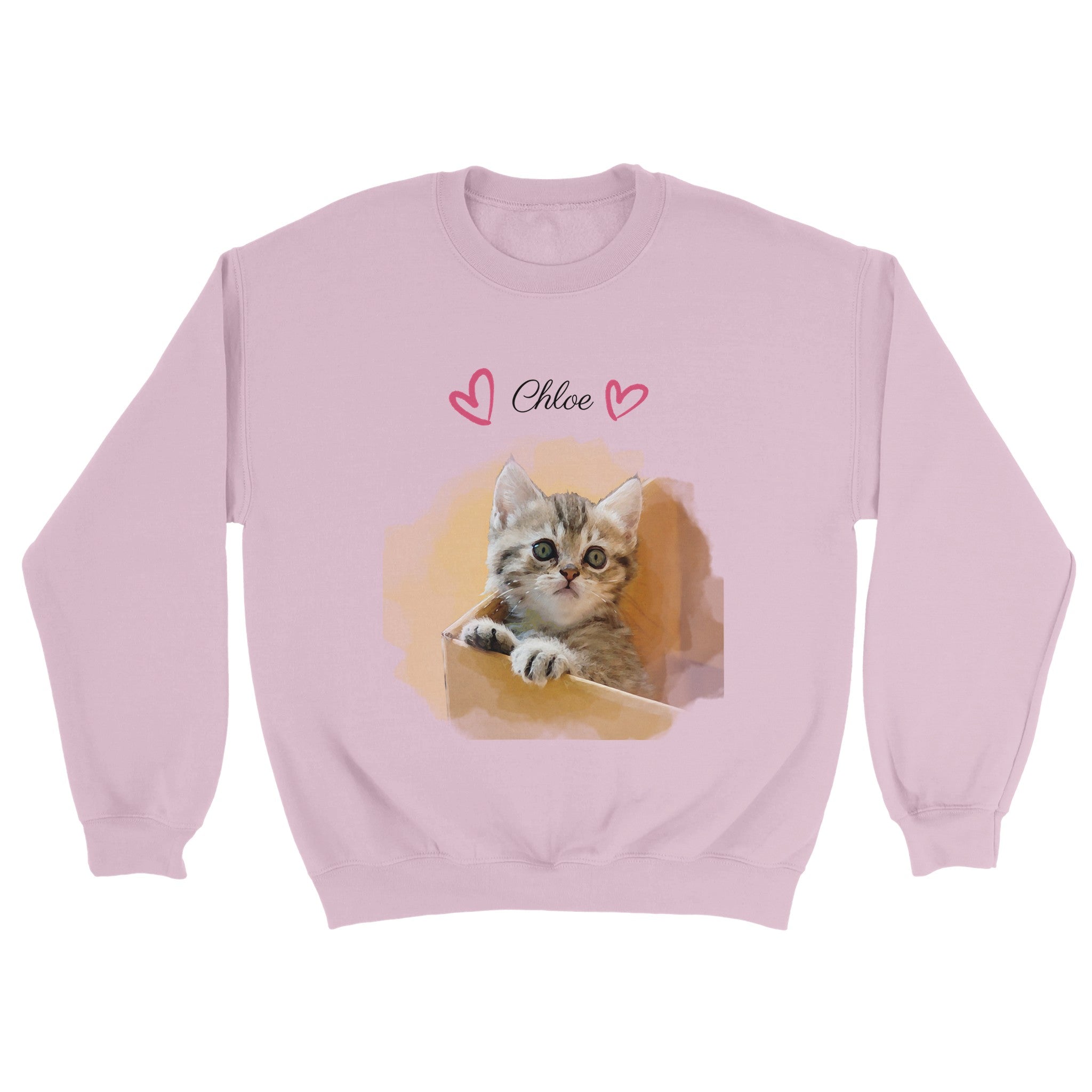 Custom watercolor pet portrait on pink sweatshirt. Tabby kitten in cardboard box. Pet name at the top of sweatshirt. Name has pink hearts on both side of name.