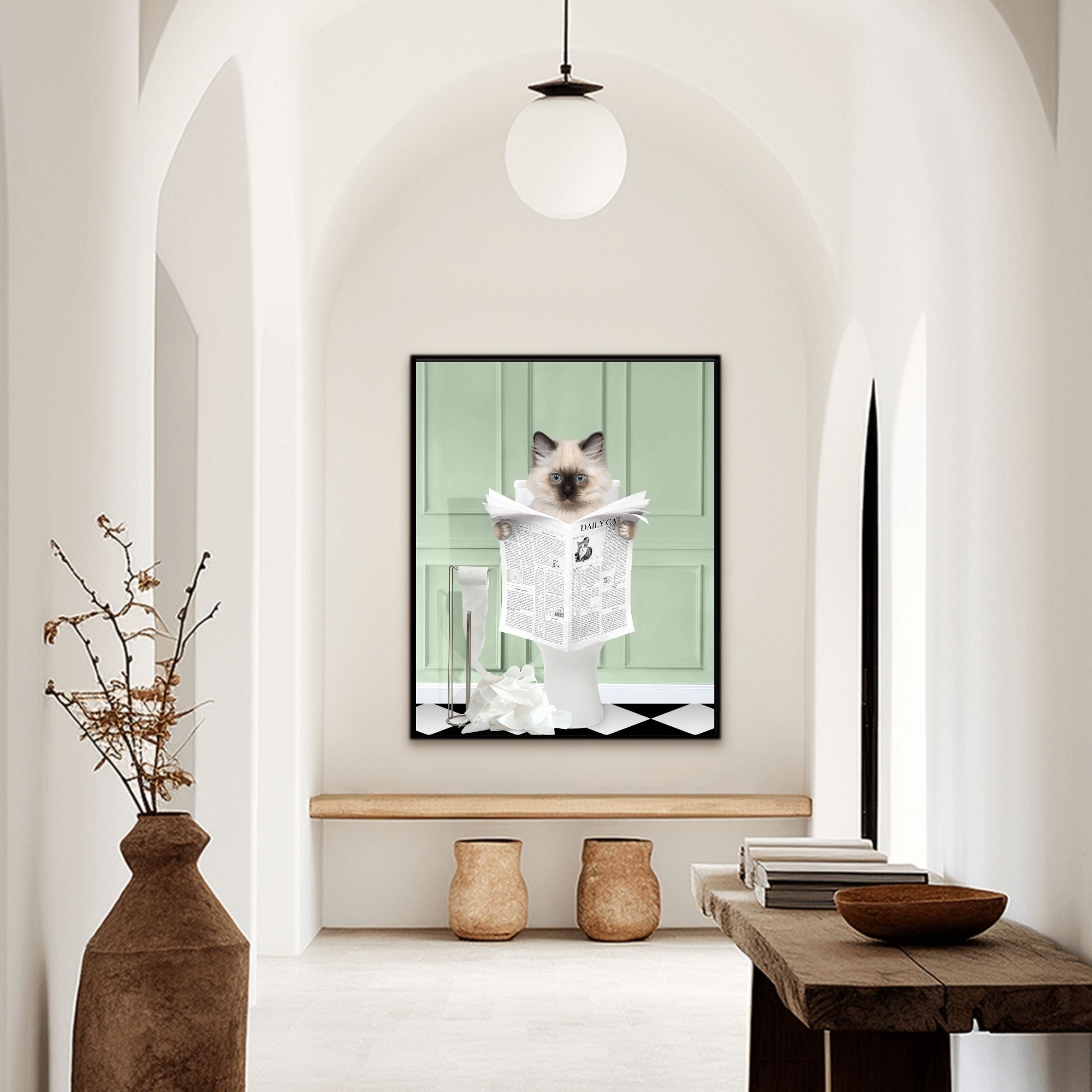 Custom bathroom cat hallway portrait. Siamese kitten holding newspaper on toilet with black and white checker tiled floor.
