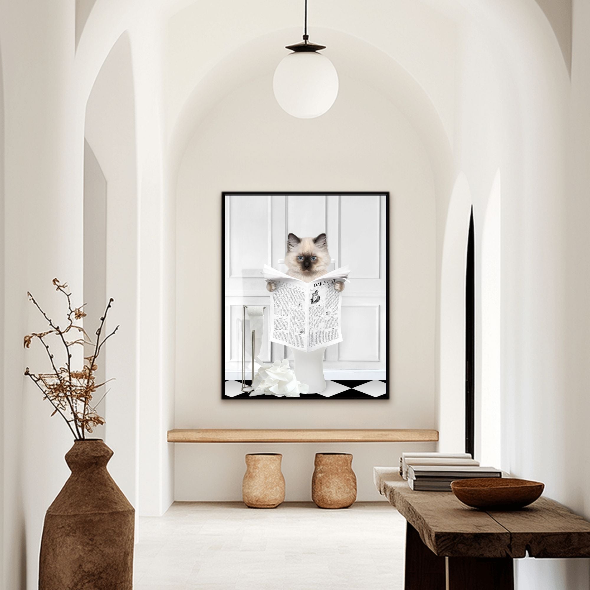 Custom bathroom cat hallway portrait. Siamese kitten holding newspaper on toilet with black and white checker tiled floor.