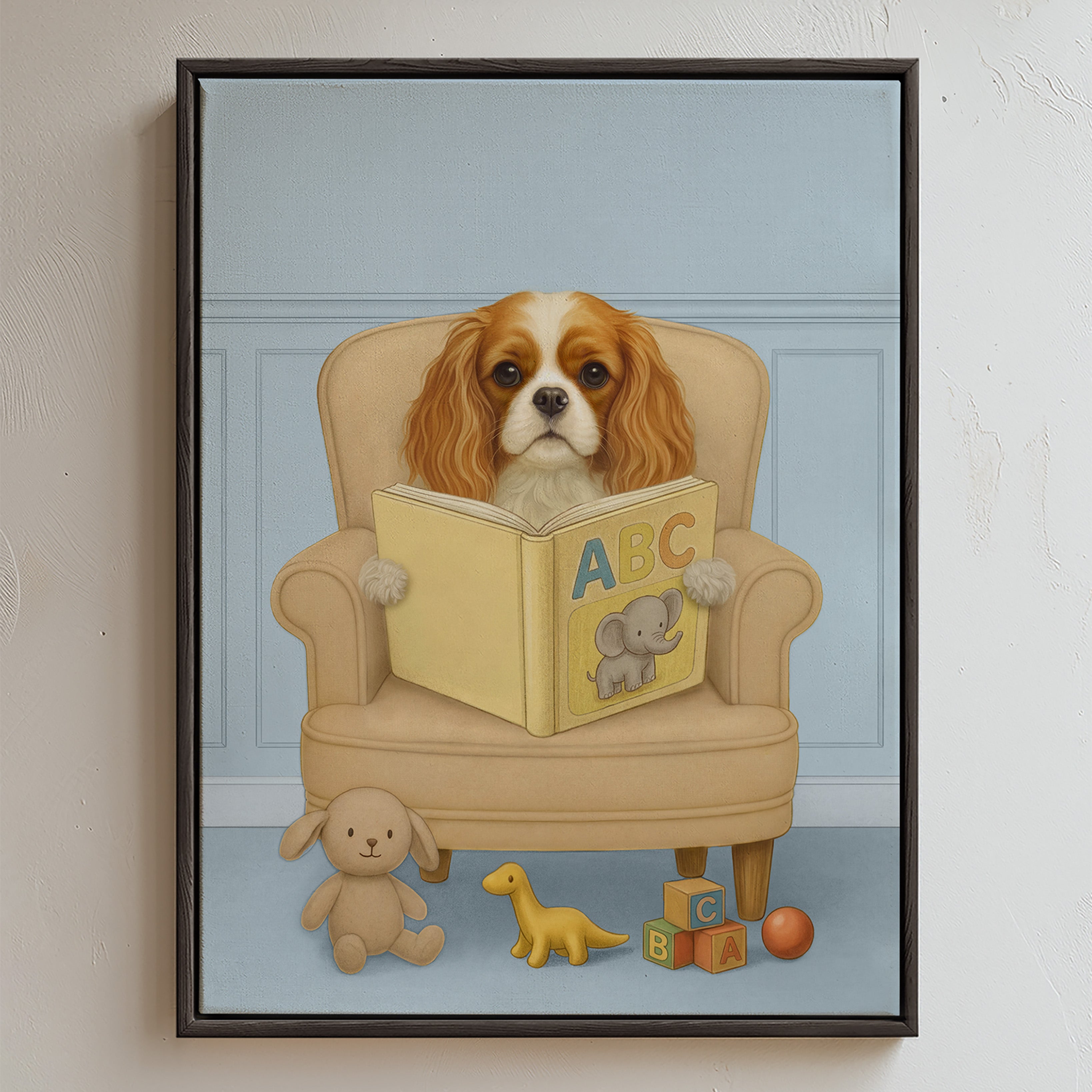 Custom pet portrait in light blue background color, showing a brown‑and‑white Cavalier King Charles Spaniel sitting comfortably in a beige armchair, holding a yellow ABC book with an elephant illustration, surrounded by plush toys and alphabet blocks.