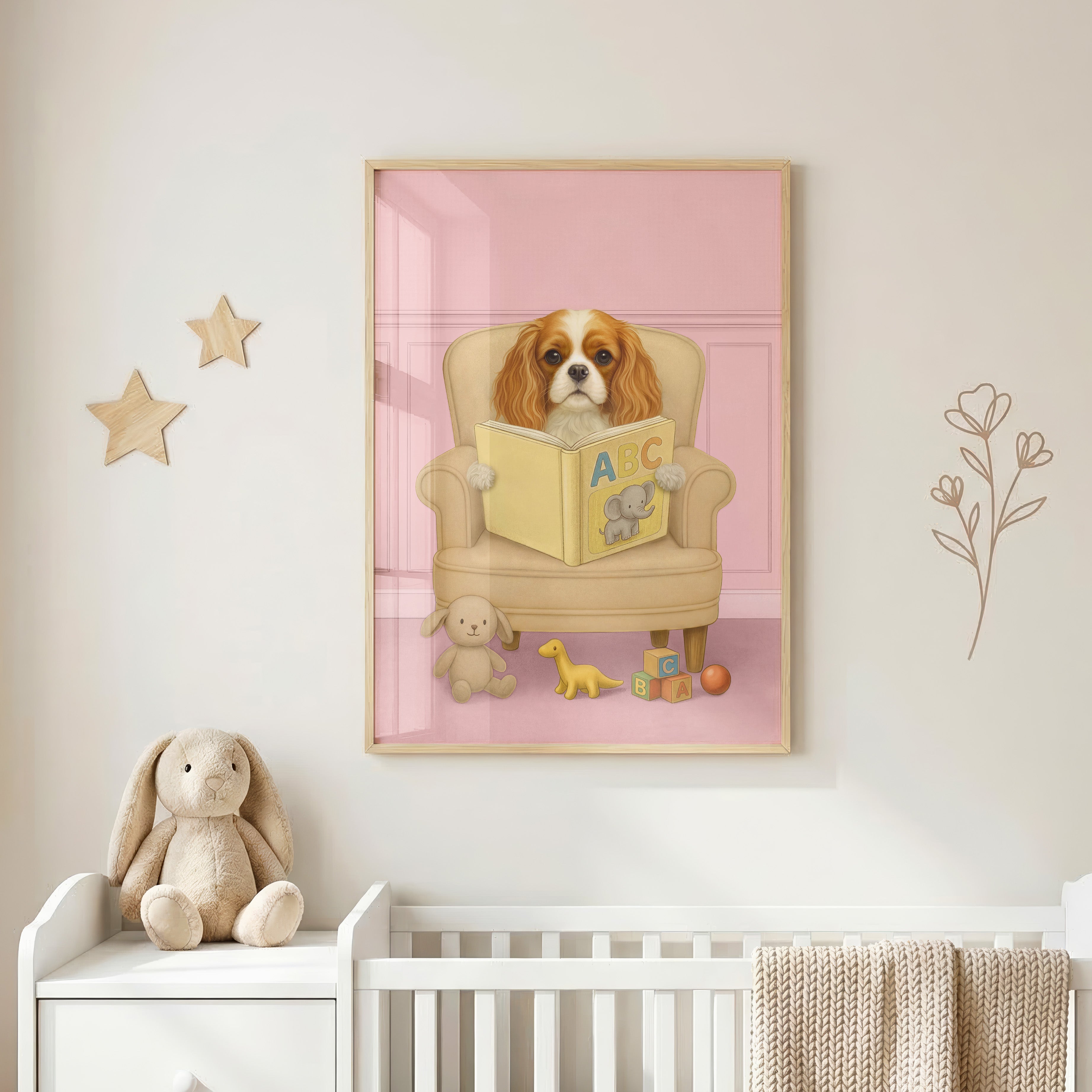 Close-up of custom pet portrait in baby pink background color, showing a pup reading a yellow ABC book with an elephant illustration, surrounded by plush toys and alphabet blocks.